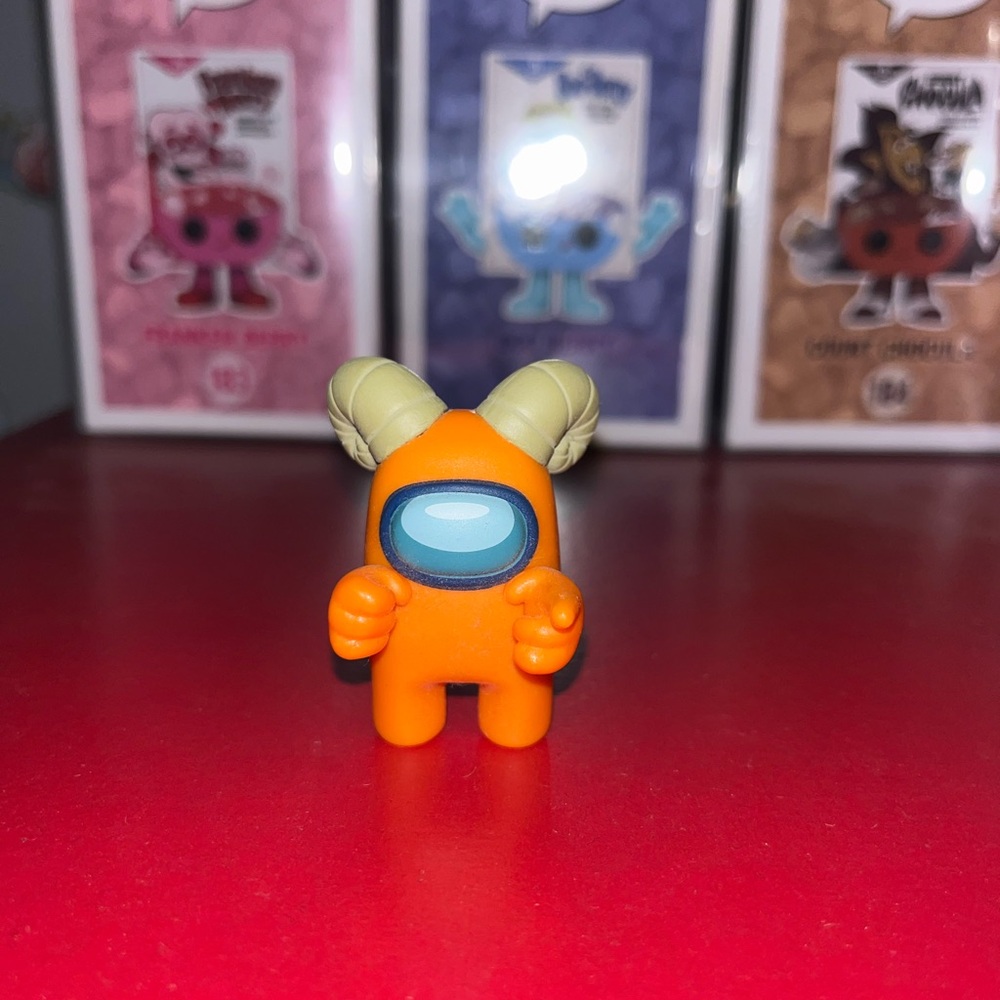 Orange Among Us figure with goat horns